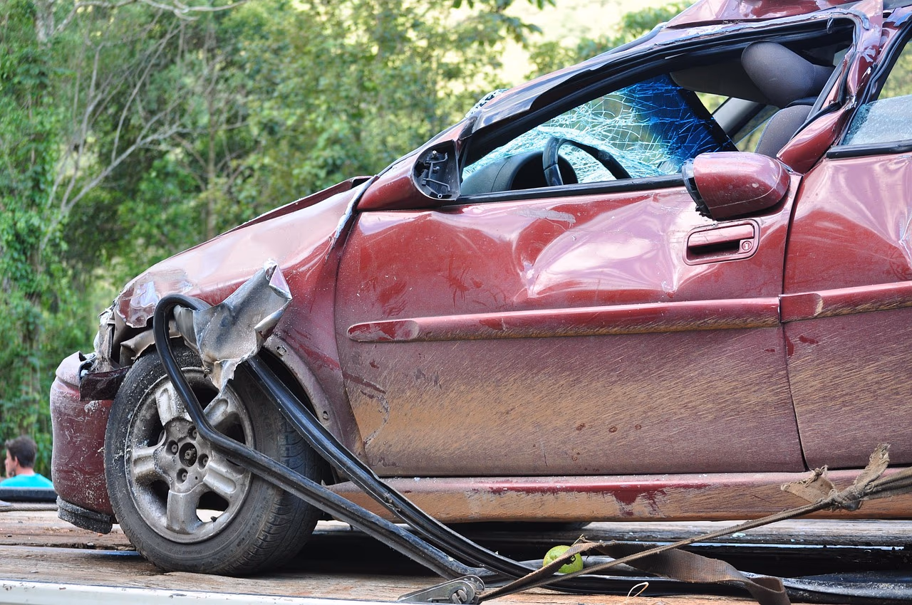 Red car with a crushed front end after a crash